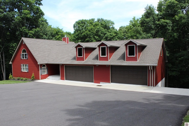 cape cod home with a garage