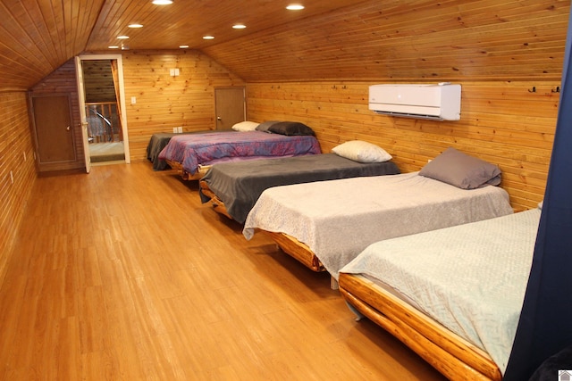 bedroom featuring wood ceiling, light wood-type flooring, wood walls, vaulted ceiling, and a wall mounted AC