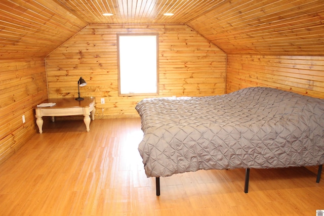 bedroom featuring wooden ceiling, light hardwood / wood-style floors, wooden walls, and lofted ceiling