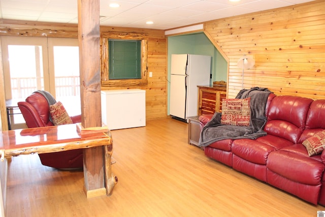 living room featuring wood walls and hardwood / wood-style floors