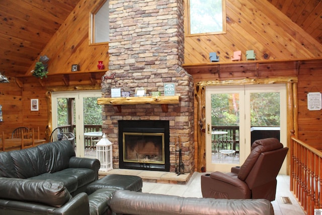 tiled living room featuring high vaulted ceiling, plenty of natural light, and a stone fireplace