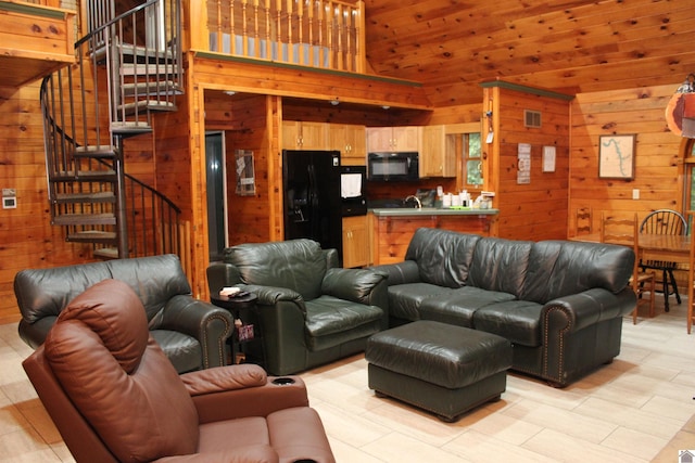 living room with wood walls and a towering ceiling