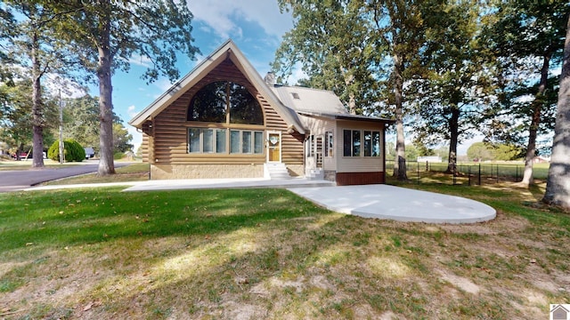 rear view of property featuring a yard