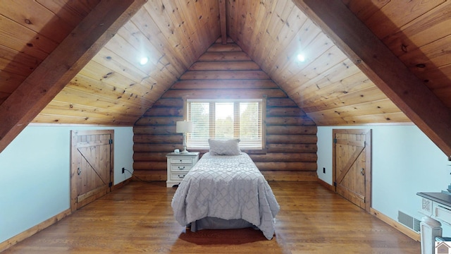 unfurnished bedroom with vaulted ceiling with beams, rustic walls, and light hardwood / wood-style floors