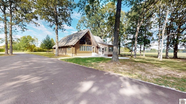 log-style house with a front yard