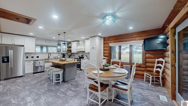 dining area with rustic walls