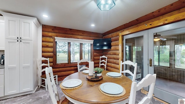 dining space featuring rustic walls and a wealth of natural light