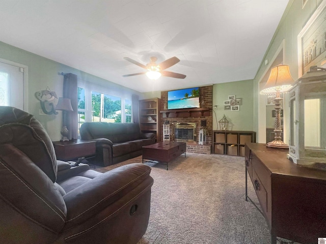 carpeted living room with a brick fireplace and ceiling fan