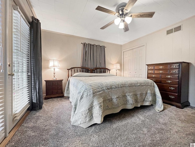 carpeted bedroom featuring a closet and ceiling fan