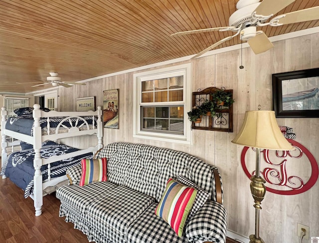 bedroom featuring wood ceiling, wooden walls, ceiling fan, and hardwood / wood-style floors