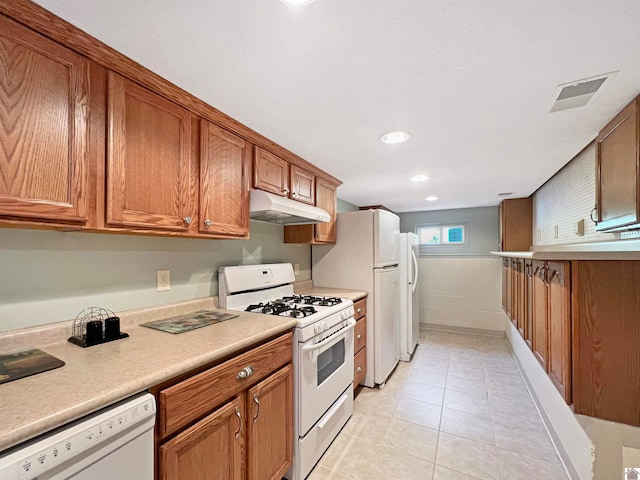 kitchen featuring light tile patterned floors and white appliances