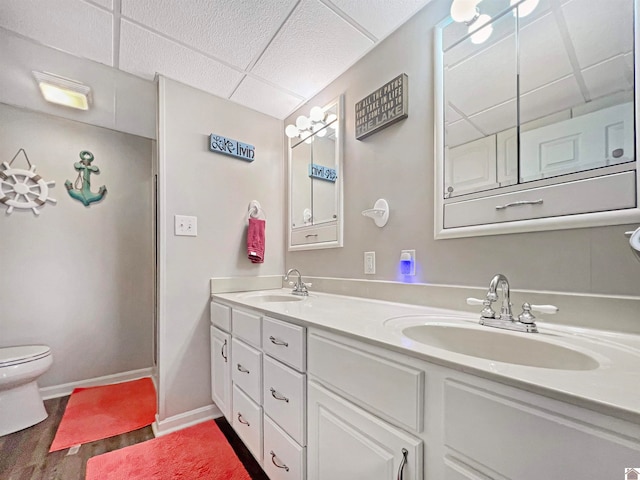 bathroom featuring wood-type flooring, vanity, and toilet