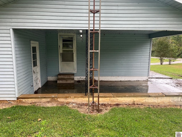 doorway to property with a yard