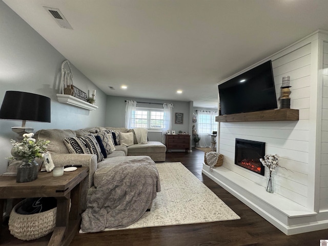 living room with a fireplace and dark hardwood / wood-style floors