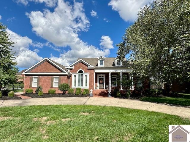 view of front of house featuring a front lawn and covered porch