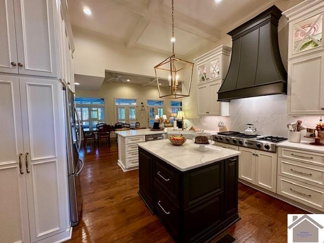 kitchen featuring custom exhaust hood, kitchen peninsula, appliances with stainless steel finishes, a center island, and dark hardwood / wood-style flooring