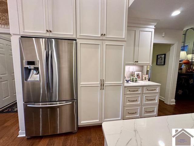 kitchen featuring white cabinets, dark hardwood / wood-style floors, and stainless steel fridge with ice dispenser