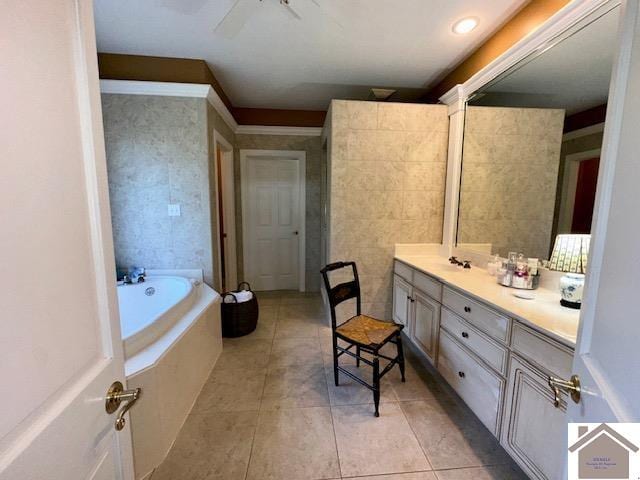 bathroom with tile patterned flooring, a bath, and vanity