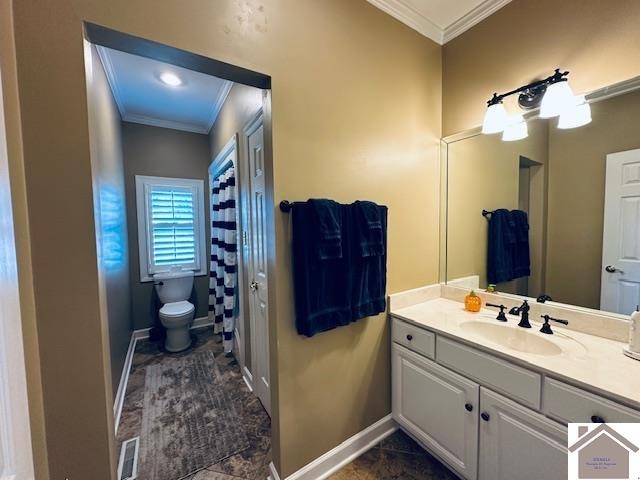 bathroom with crown molding, vanity, and toilet