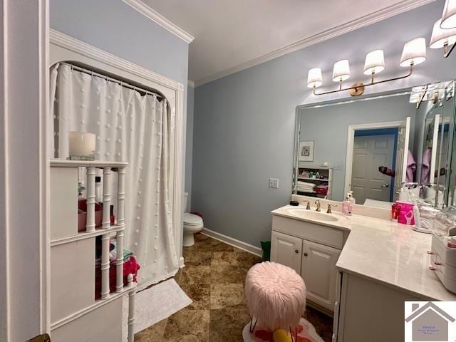 bathroom with crown molding, vanity, and toilet