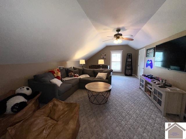 living room with ceiling fan, carpet floors, and lofted ceiling