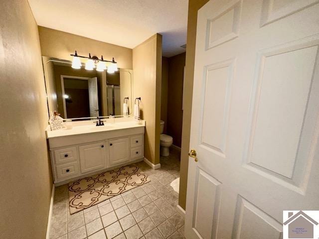 bathroom with tile patterned floors, vanity, and toilet