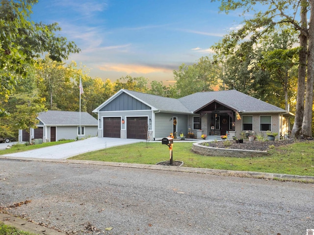 view of front of home featuring a garage and a yard