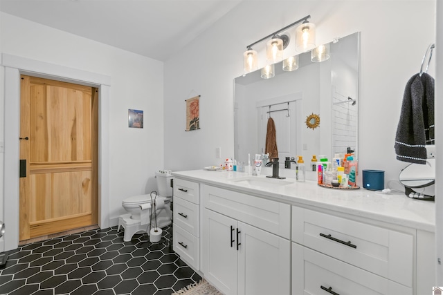 bathroom with tile patterned floors, vanity, and toilet