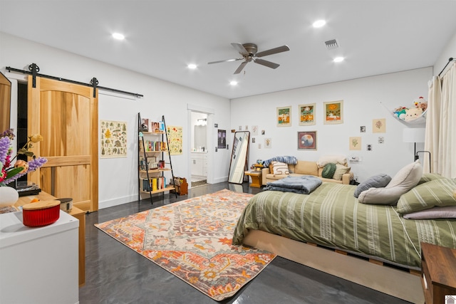 bedroom featuring a barn door, dark hardwood / wood-style flooring, and ceiling fan