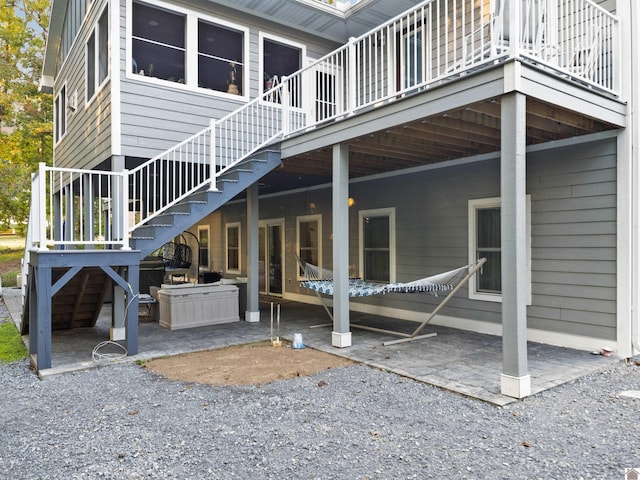 rear view of property featuring a patio and a wooden deck