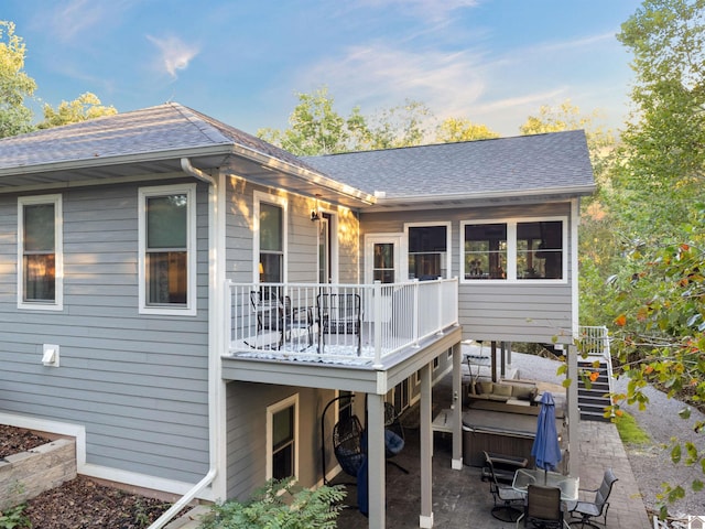 rear view of house with a patio and a deck