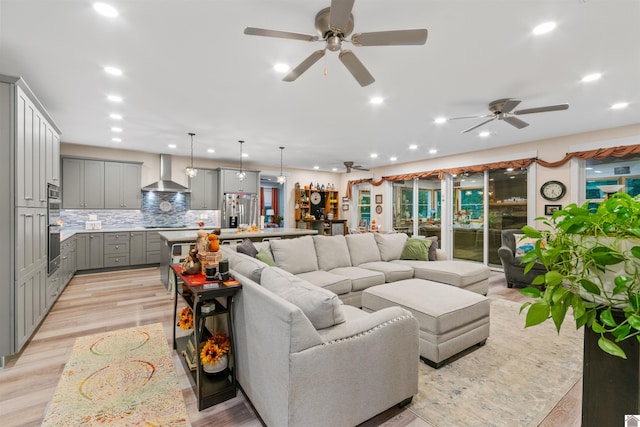 living room with light wood-type flooring and ceiling fan