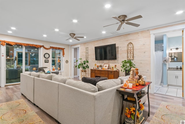 living room featuring light hardwood / wood-style floors and ceiling fan