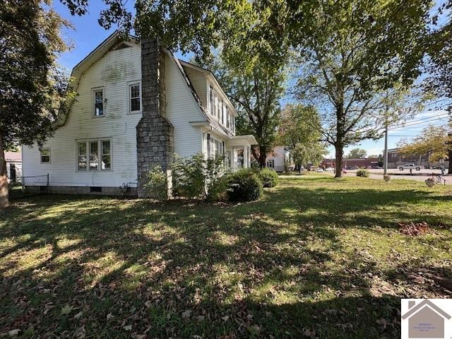 view of property exterior featuring a lawn