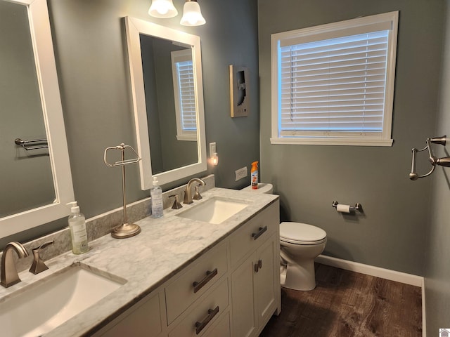 bathroom featuring wood-type flooring, vanity, and toilet