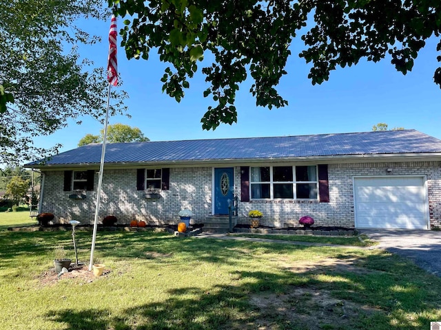 single story home featuring a front lawn and a garage