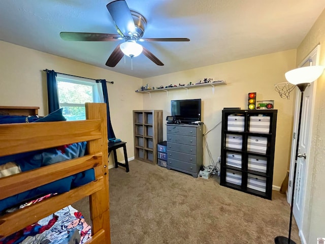 bedroom with ceiling fan and light carpet