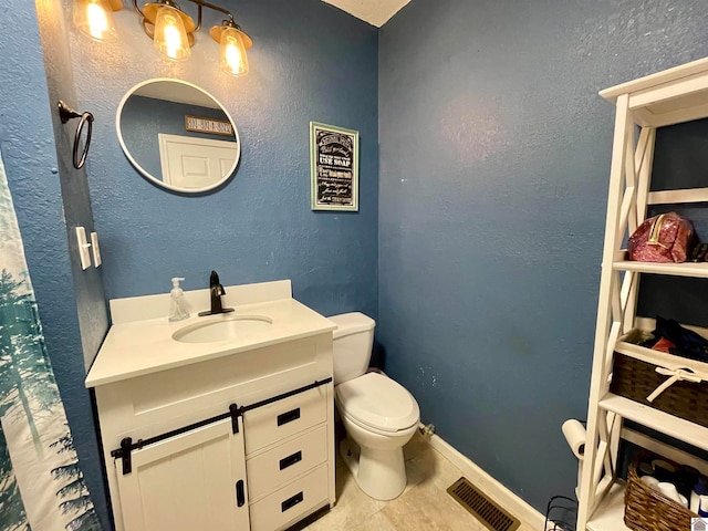 bathroom with walk in shower, vanity, toilet, and tile patterned floors