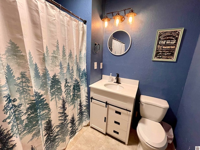 bathroom with tile patterned flooring, vanity, and toilet