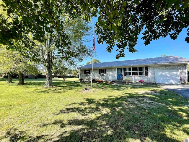 ranch-style house featuring a garage and a front lawn