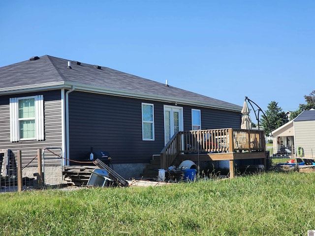 back of property featuring a yard and a deck