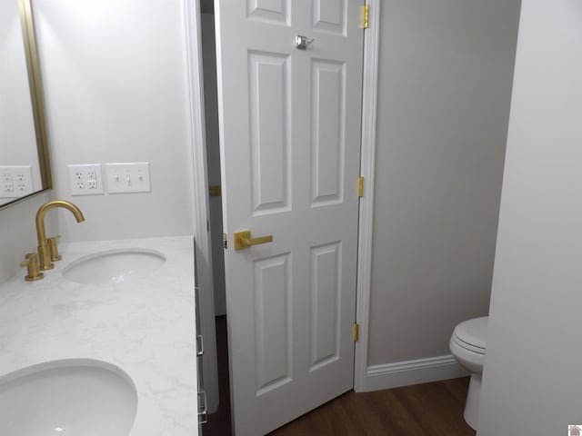 bathroom featuring hardwood / wood-style floors, toilet, and vanity