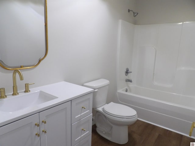 full bathroom featuring hardwood / wood-style flooring, vanity, toilet, and  shower combination