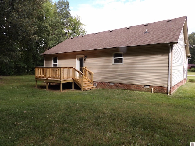 back of property with a deck and a yard