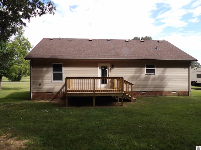 rear view of property with a wooden deck and a yard