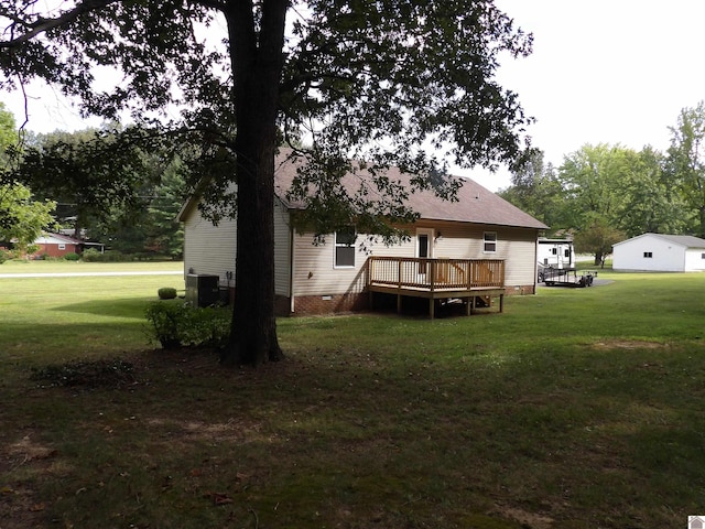 back of house with a yard, a deck, and central AC unit