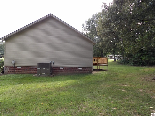 view of property exterior featuring cooling unit, a deck, and a yard