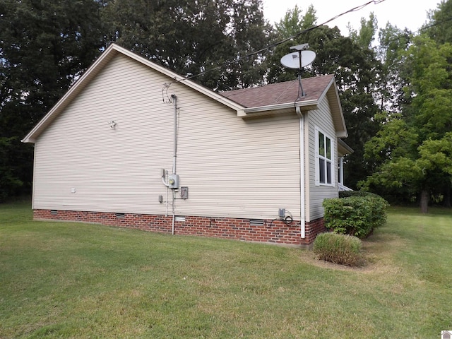 view of side of home featuring a yard