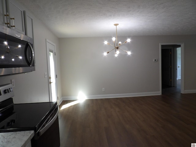 unfurnished dining area with a notable chandelier, dark wood-type flooring, and a textured ceiling