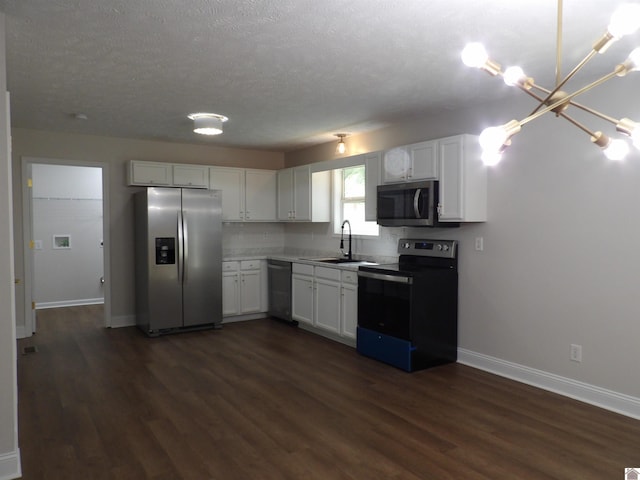 kitchen featuring dark wood-type flooring, stainless steel appliances, and white cabinets